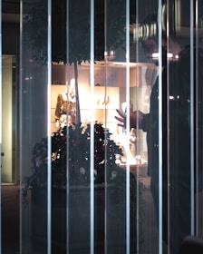 A technician carefully installing a transparent LED film on a retail storefront window.