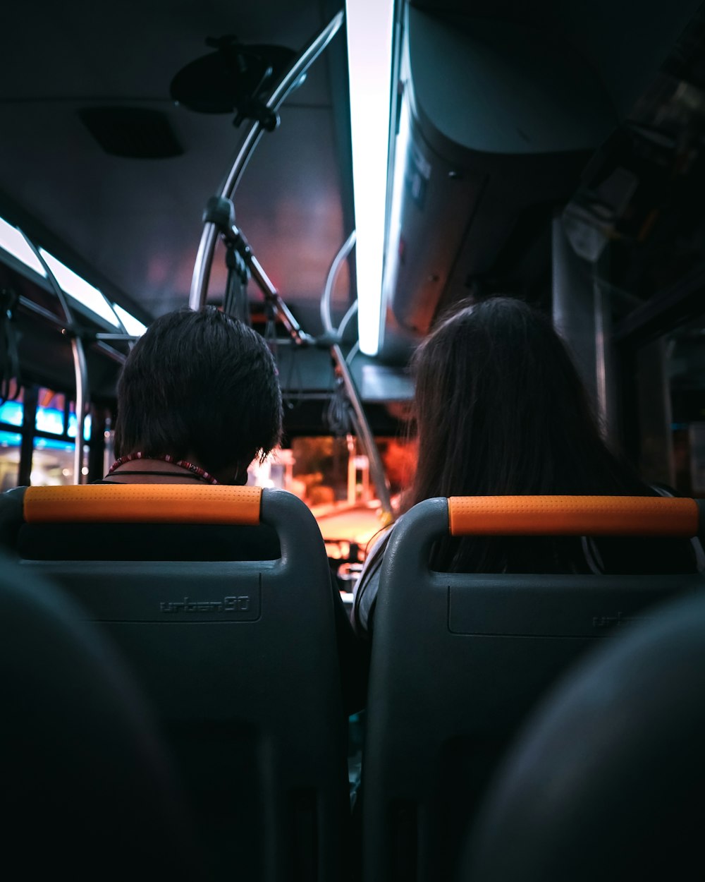 a couple of people sitting on a bus