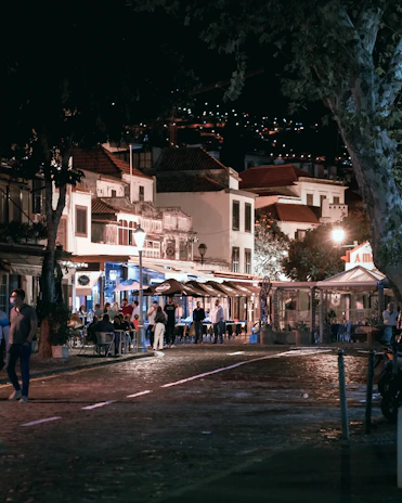 Evening dining scene with warmly lit restaurants and people enjoying meals together on Boundary Road.