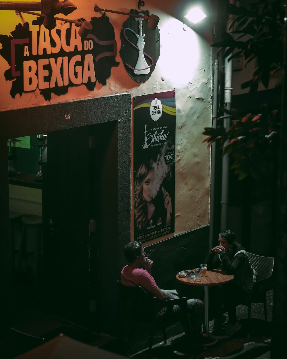 two people sitting at a table in a restaurant