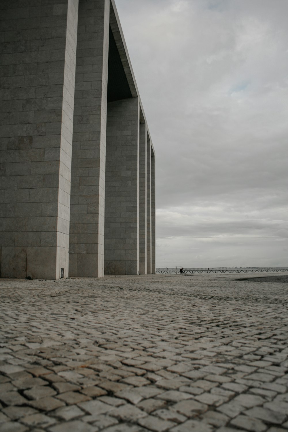 a person is walking on a cobblestone street