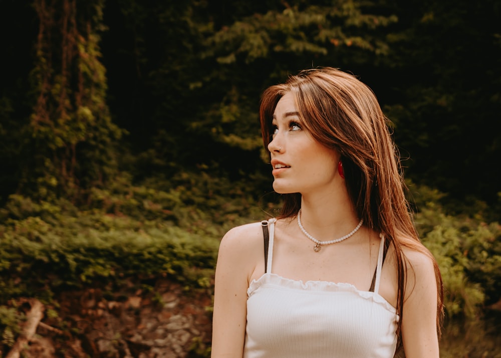 a woman standing in front of a forest