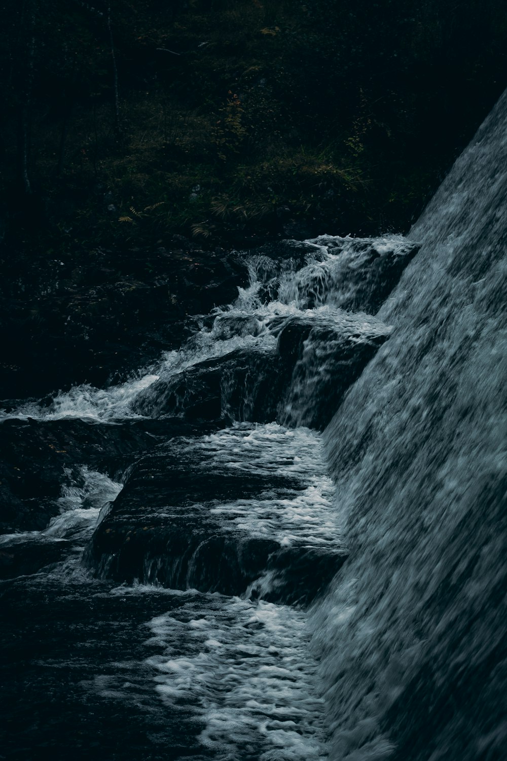 a man standing on top of a waterfall