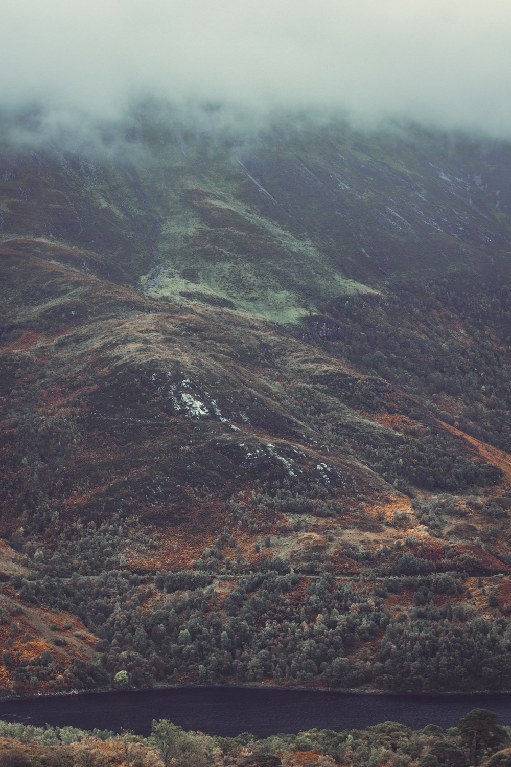 a view of a mountain with a body of water in the foreground