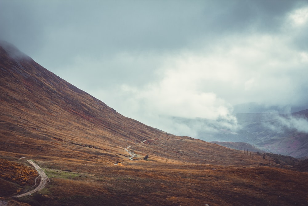 a road winding up a hill in the mountains