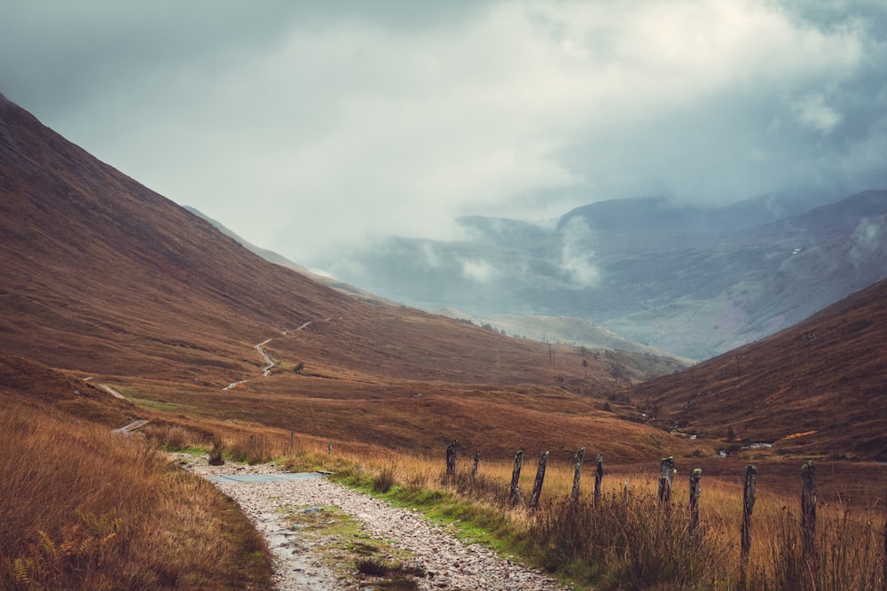 a dirt road in the middle of a mountain range