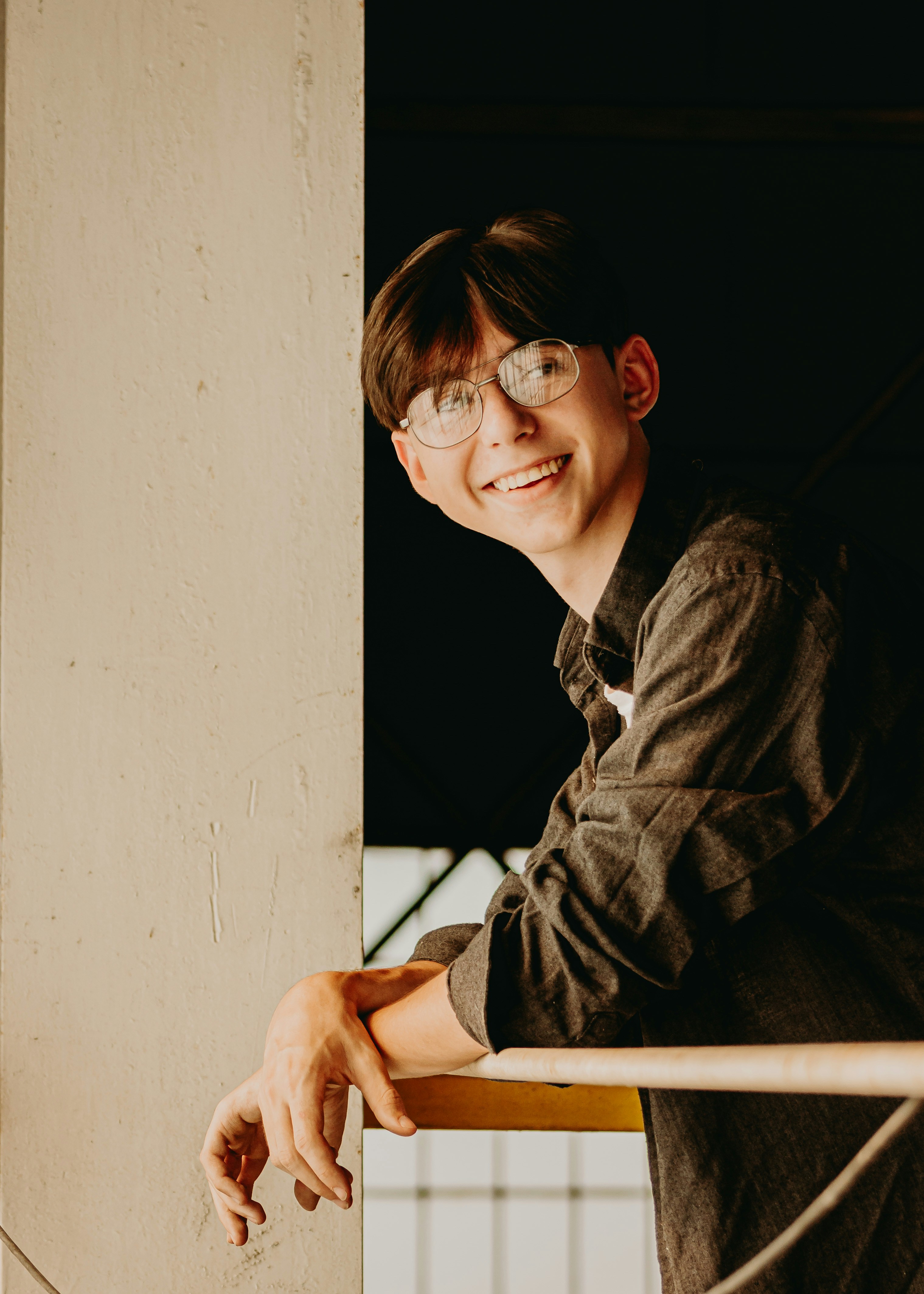 Boy leaning over rail smiling - Instagram @baileyburtonphoto - Donate to me on Cashapp! $17thcw Thank you for your support!