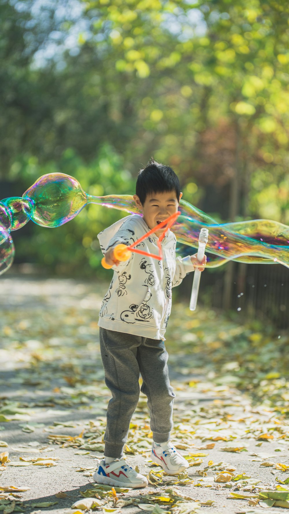 a young boy is playing with soap bubbles