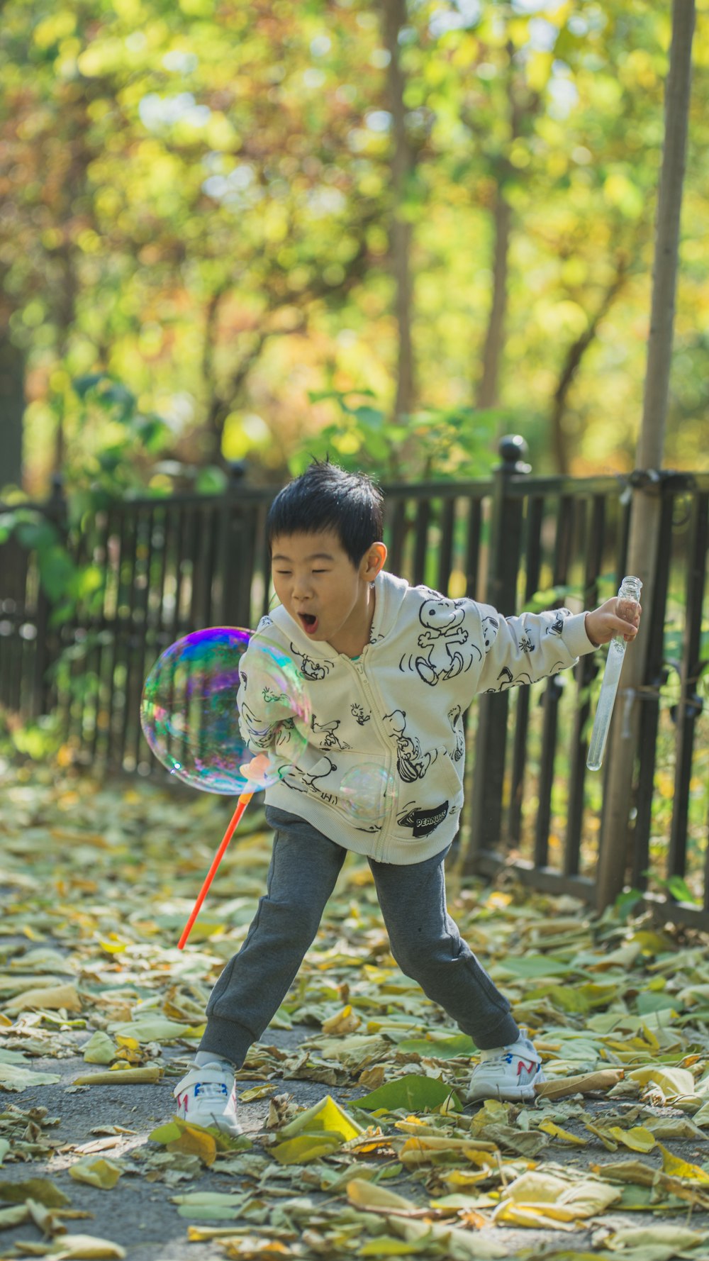 a young boy playing with a bubble wand