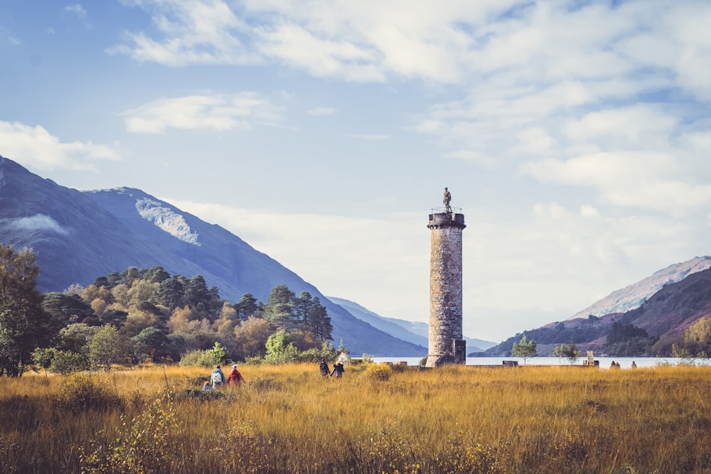 a tall tower sitting in the middle of a field