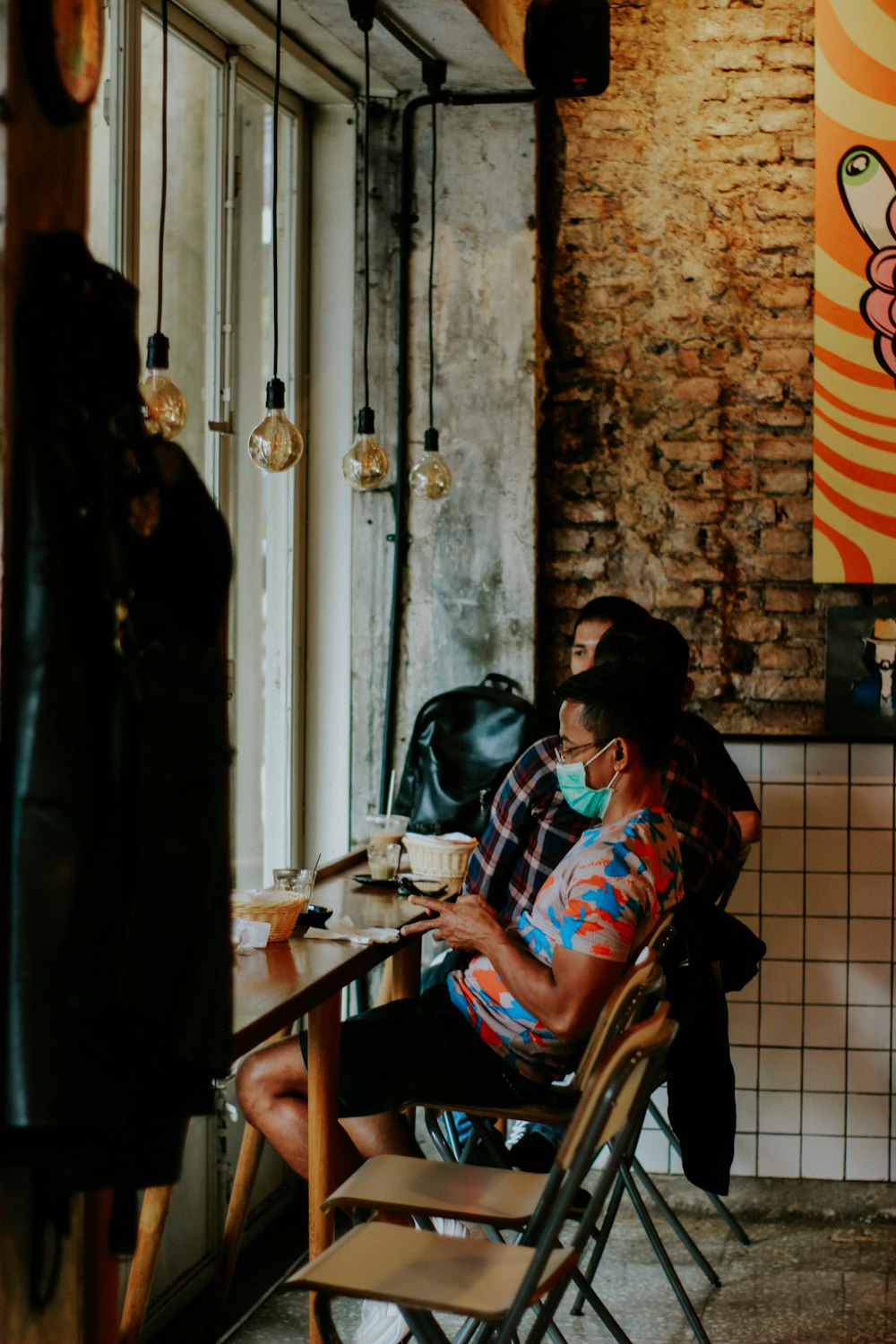 a man sitting at a table with a cup of coffee