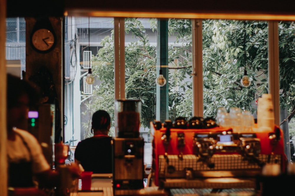 a man sitting at a table in front of a window