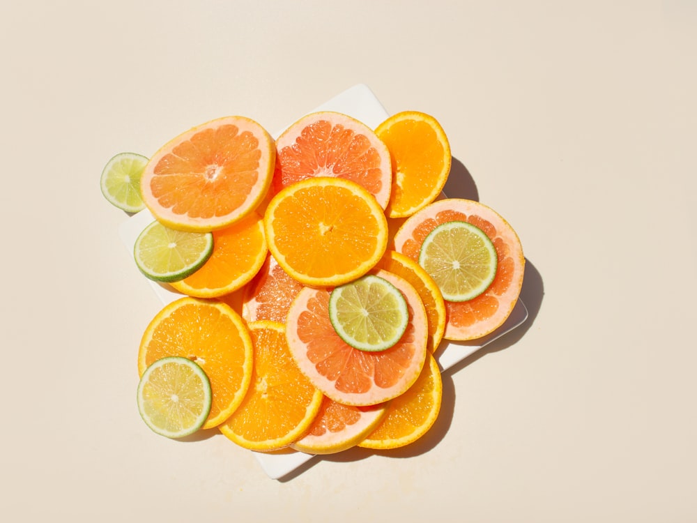 a pile of sliced oranges and limes on a napkin
