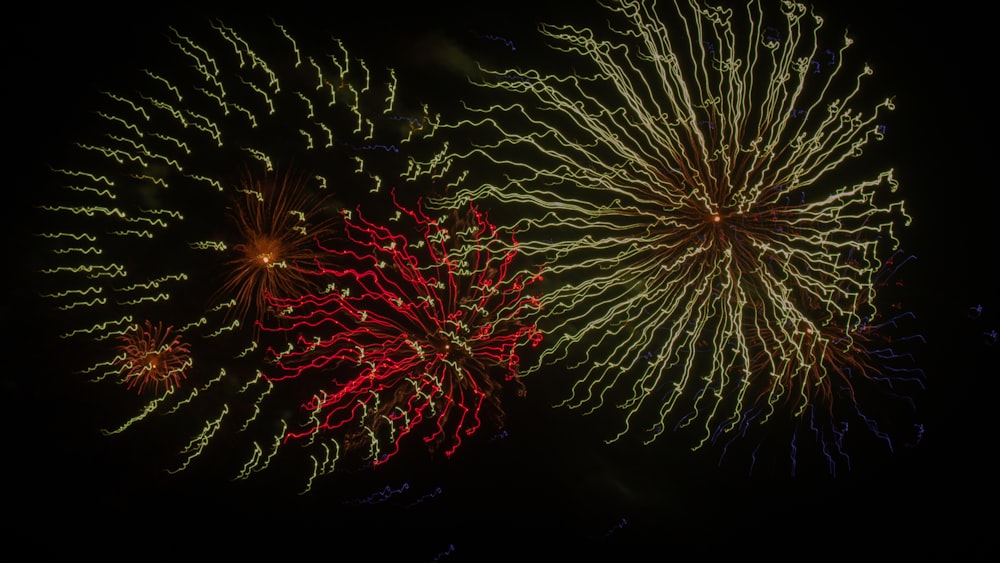 a couple of fireworks are lit up in the night sky