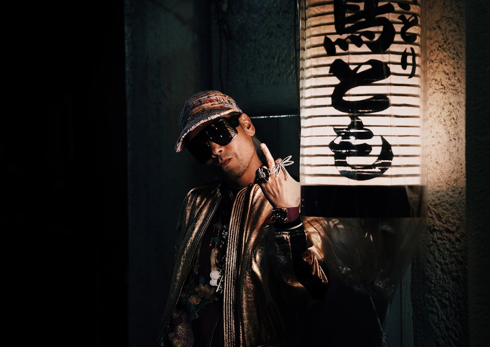 a man smoking a cigarette next to a lamp