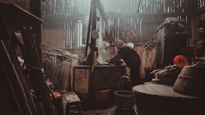 A caregiver preparing a healthy meal in the kitchen while an elderly woman watches with appreciation