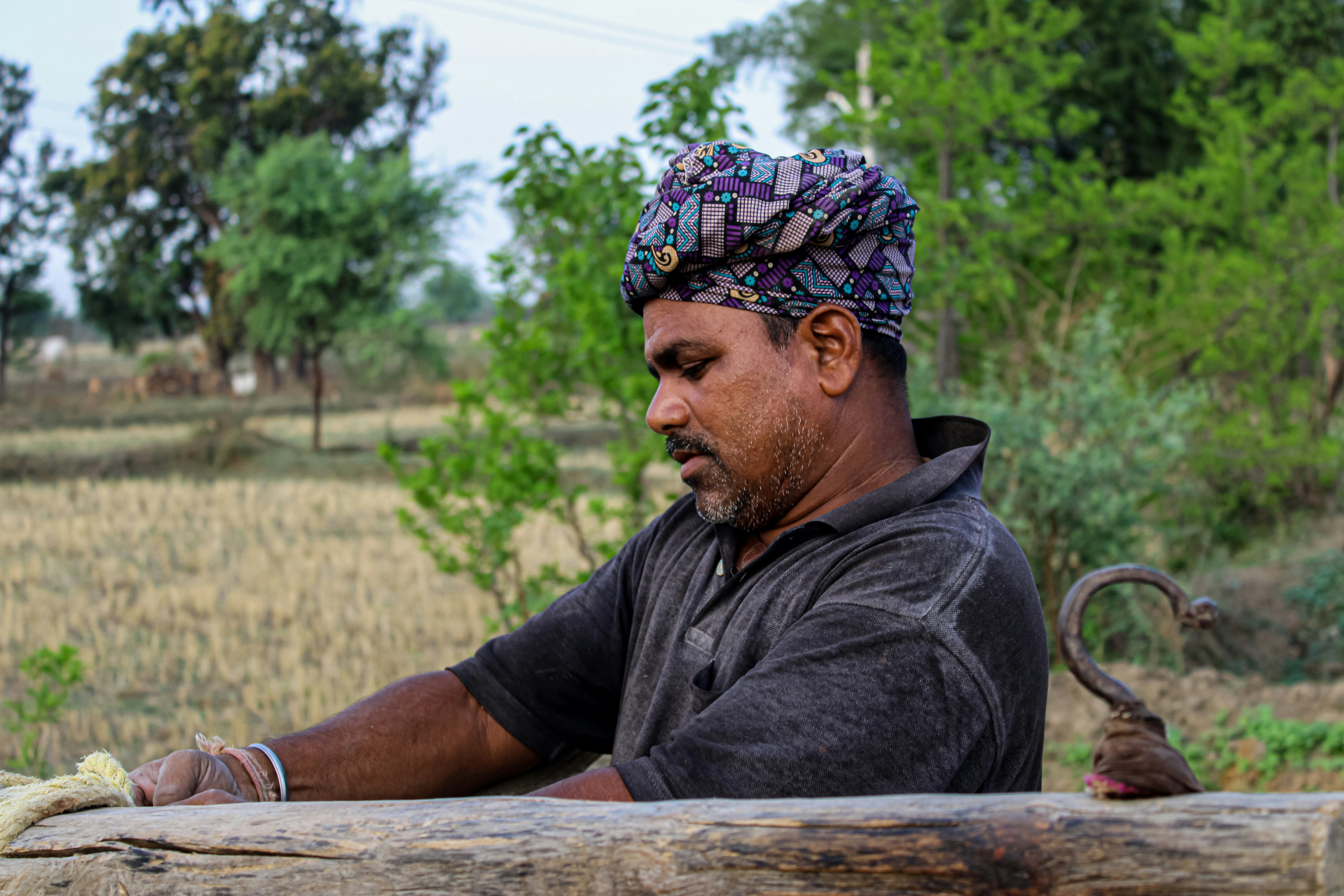 Farmer sitting on a log