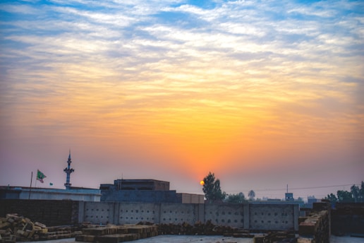 A vibrant sunrise over a historic mosque symbolizing a new beginning.