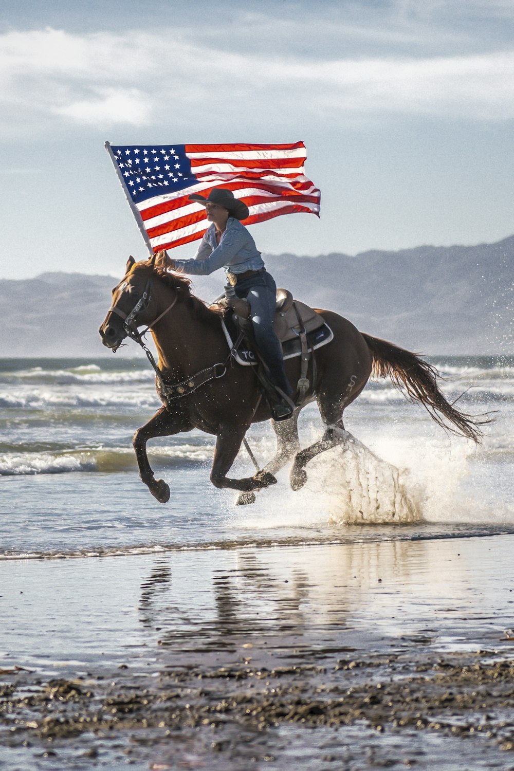 a person riding a horse with an american flag on its back