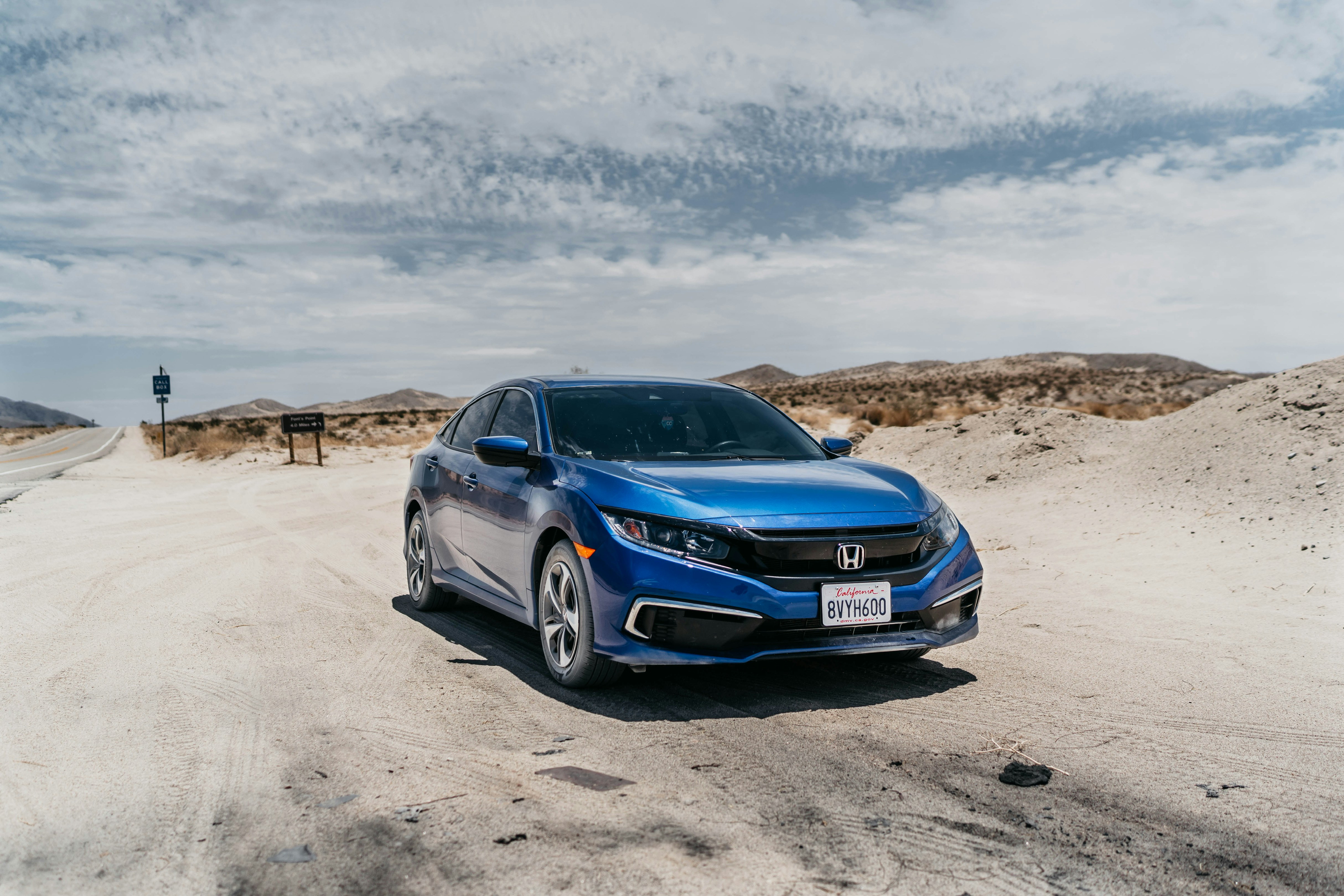 A blue car driving down a dirt road photo – Free Borrego springs Image ...