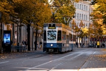 a blue and white trolley on a city street