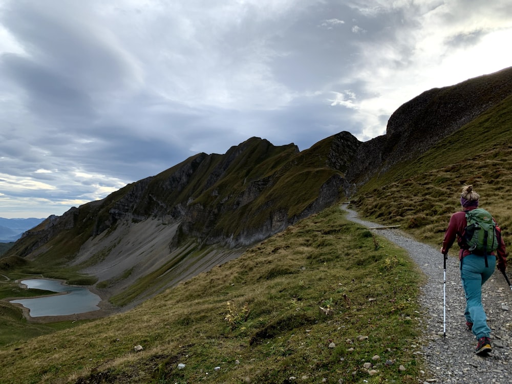 a person with a backpack walking up a hill