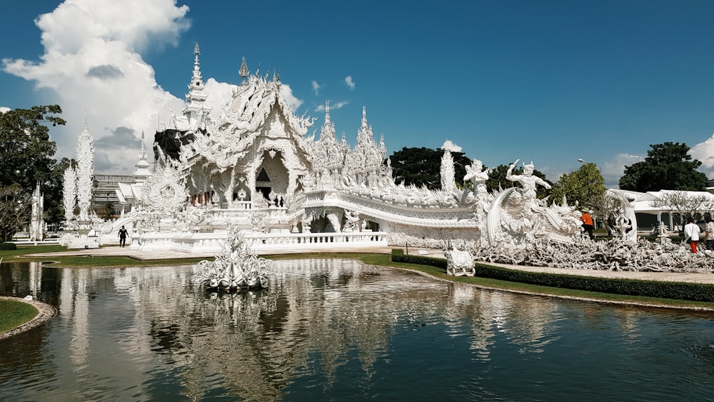 a large white building with a pond in front of it