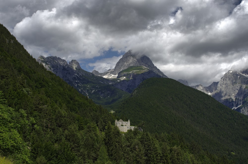 a castle in the middle of a mountain range