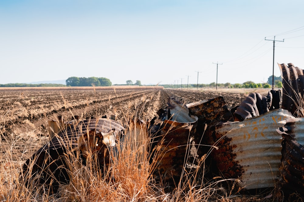 an old rusted out tractor in a field