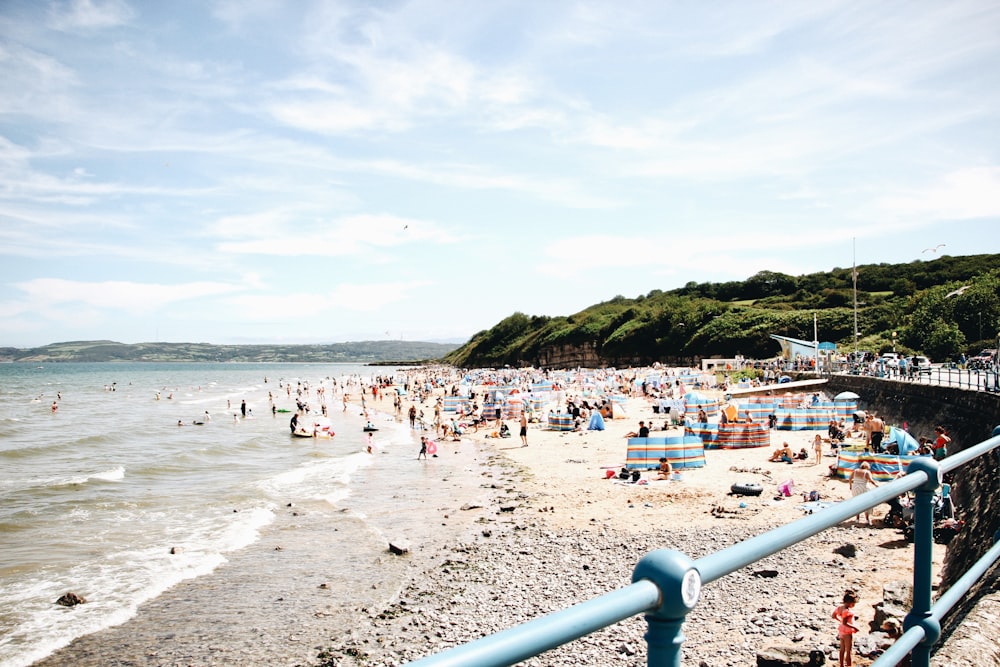 a crowded beach with many people on it