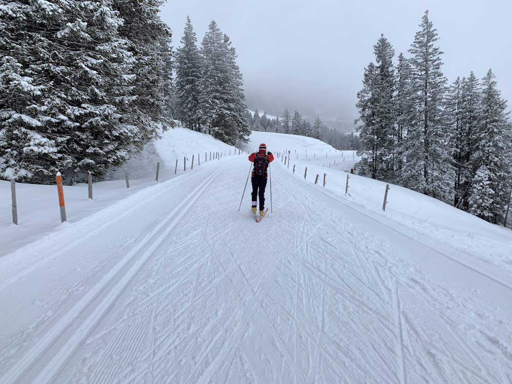 a man riding skis down a snow covered slope