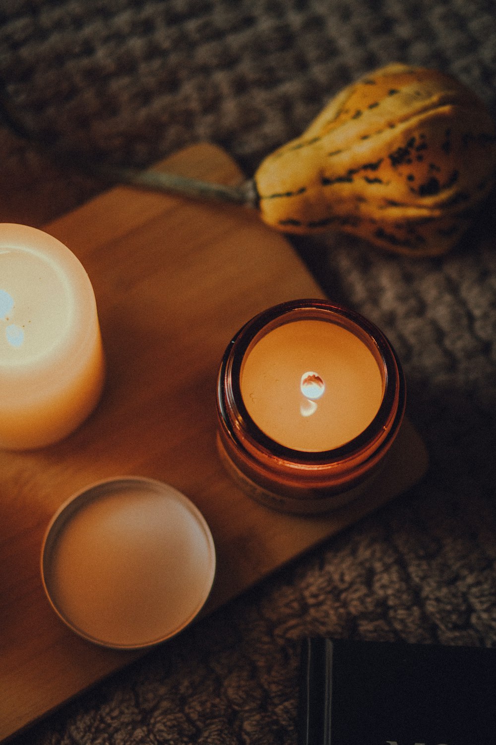 a couple of candles sitting on top of a wooden tray