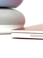 Close-up of a sleek, budget-friendly smart home assistant on a modern desk.