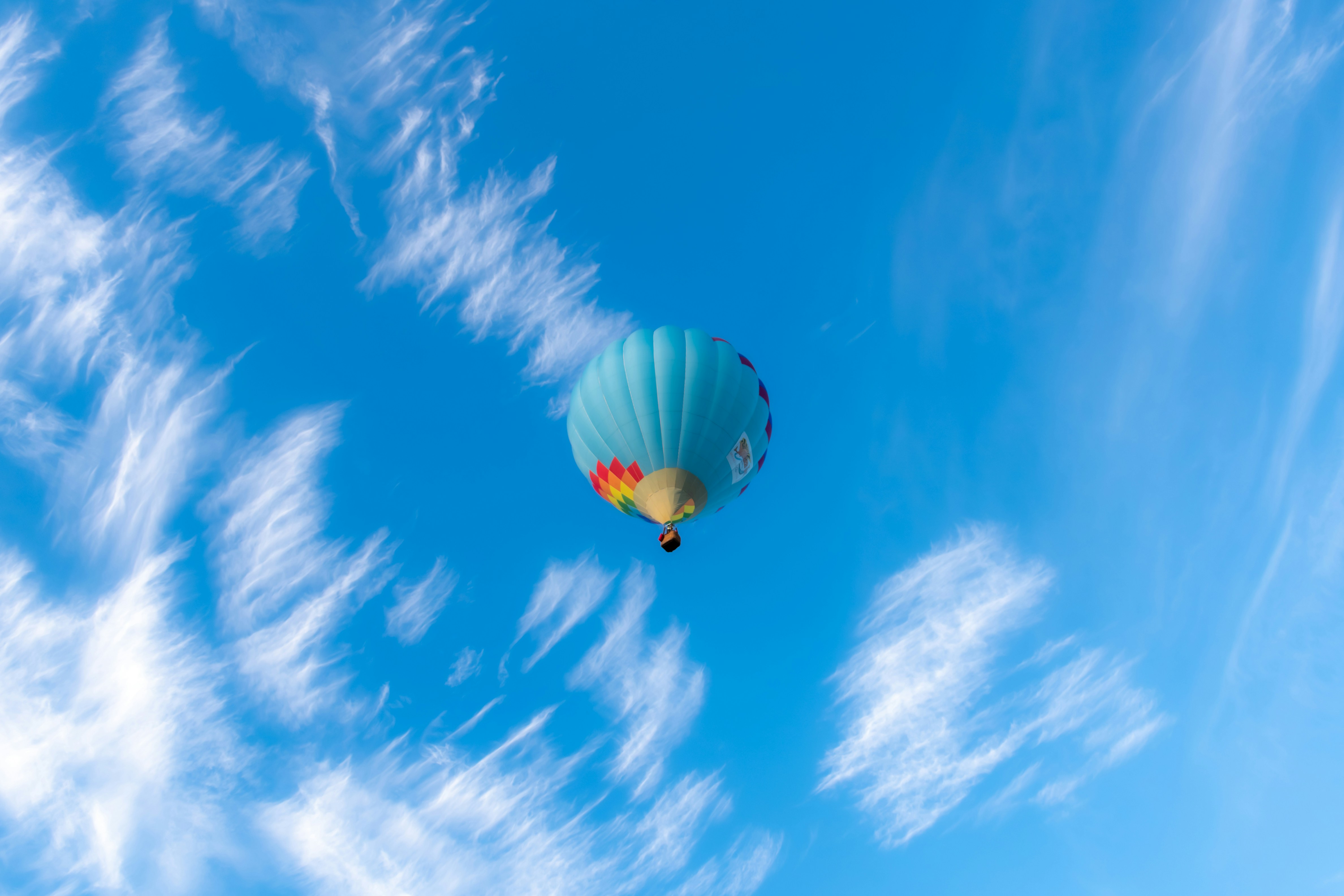 A hot air balloon flying through a blue sky photo – Free Hot air ...