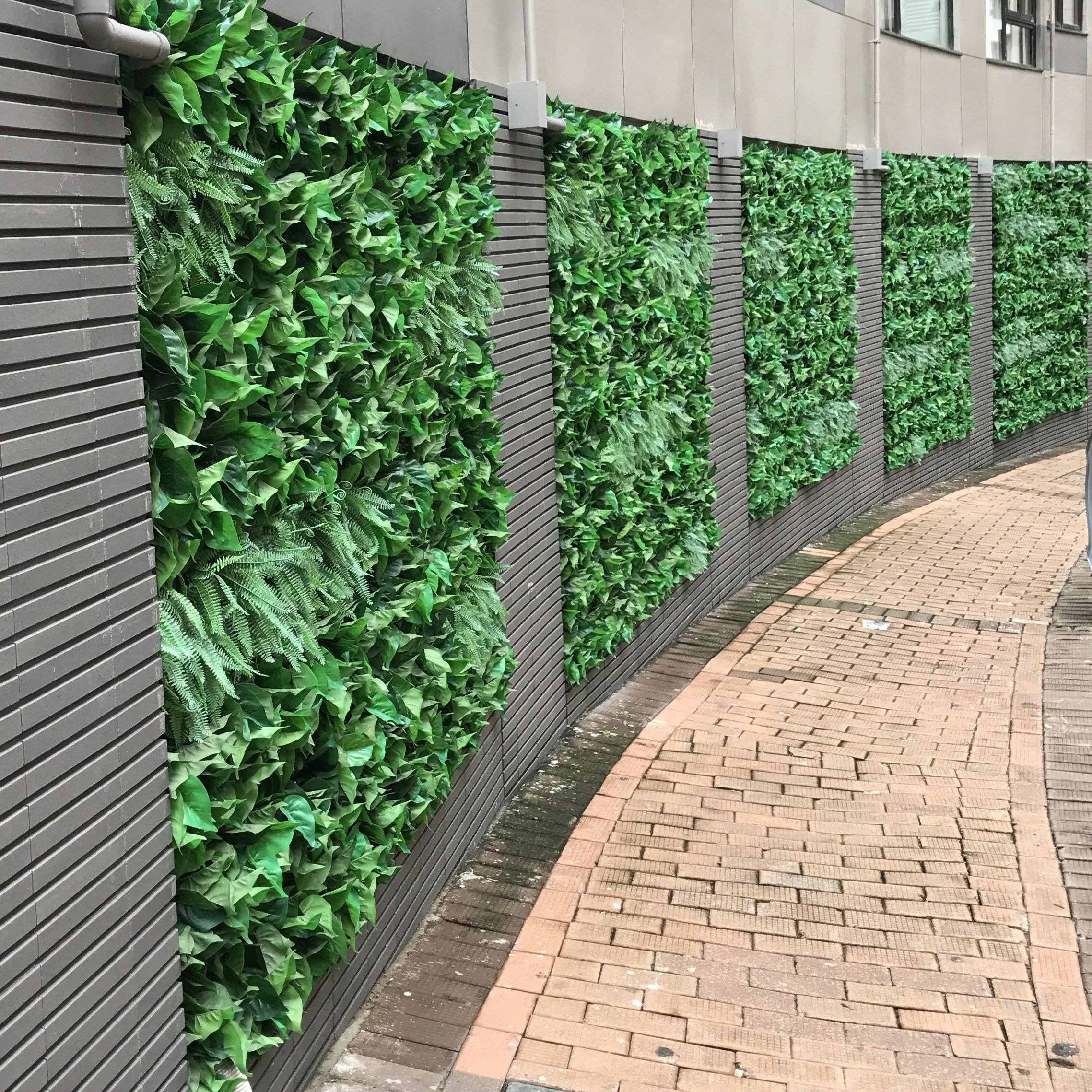 'Green' wall made of plastic plants