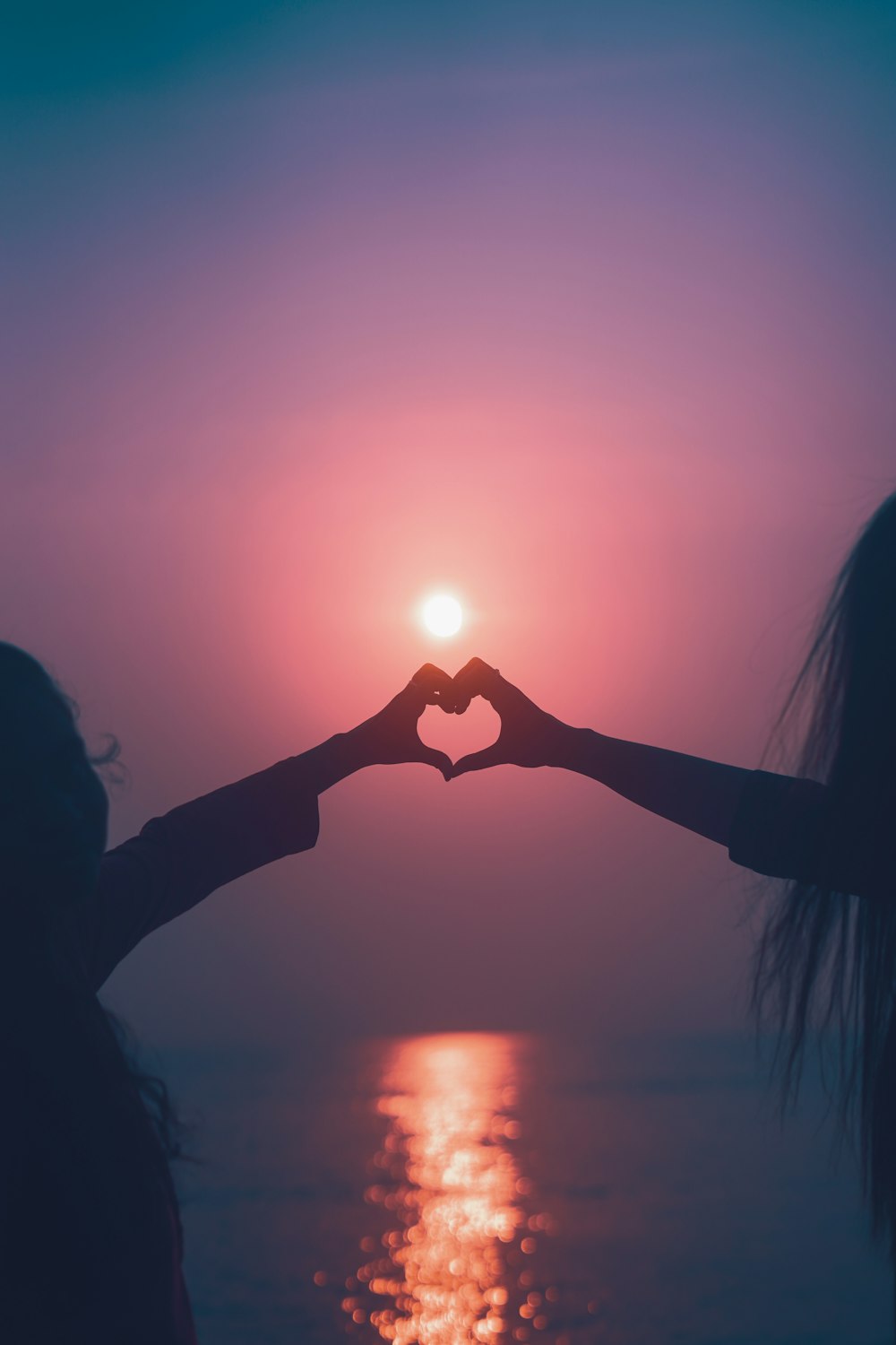 a person standing in front of a sunset