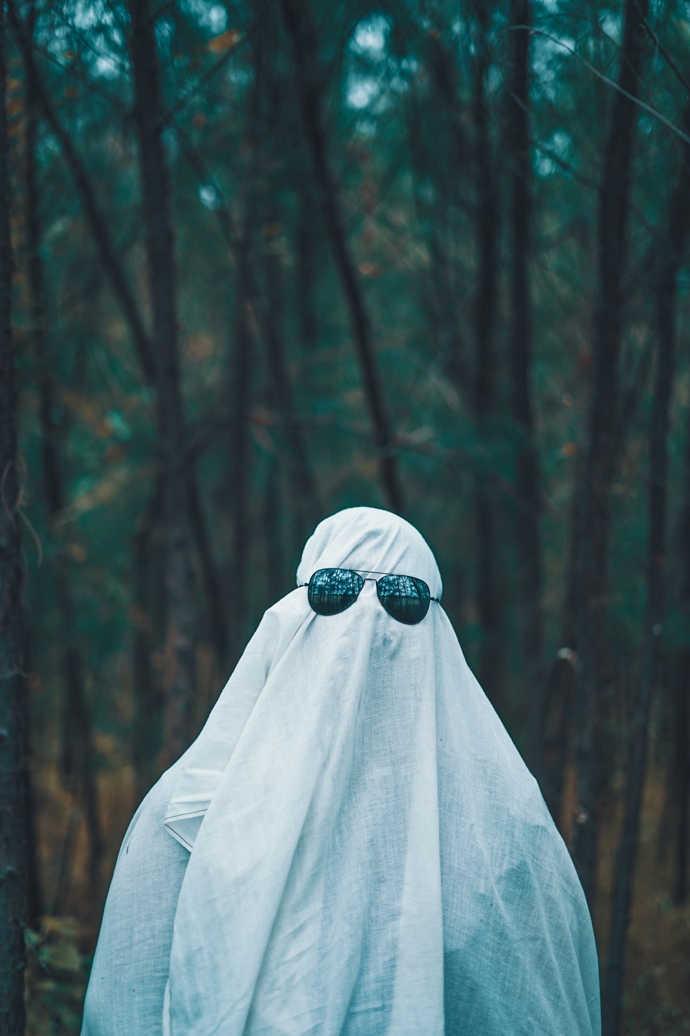 a person wearing a white cloth and sunglasses