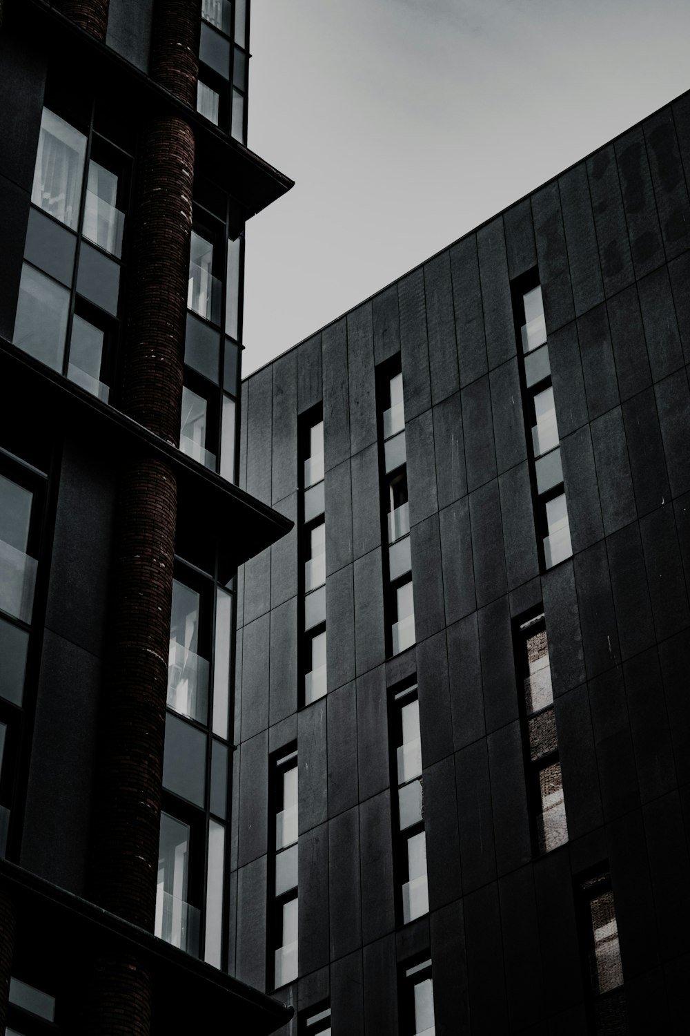 a tall building with lots of windows next to a tall building