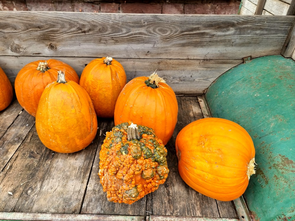 a group of pumpkins sitting on top of a wooden crate