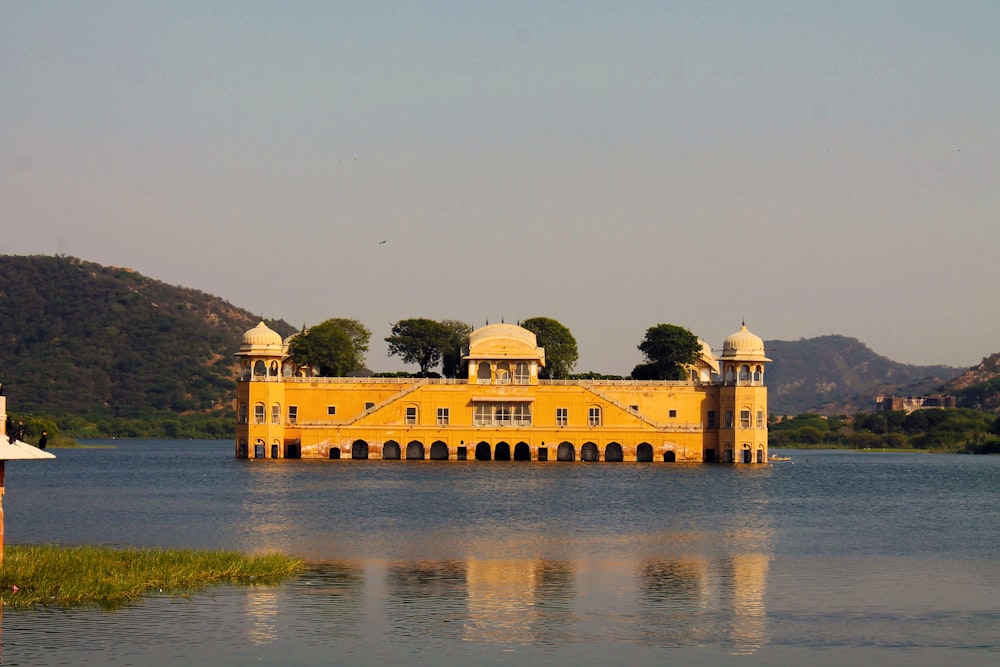 a large yellow building sitting on top of a lake