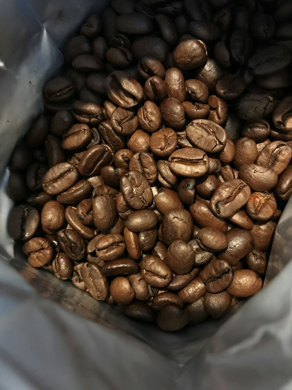 a bag full of coffee beans sitting on top of a table