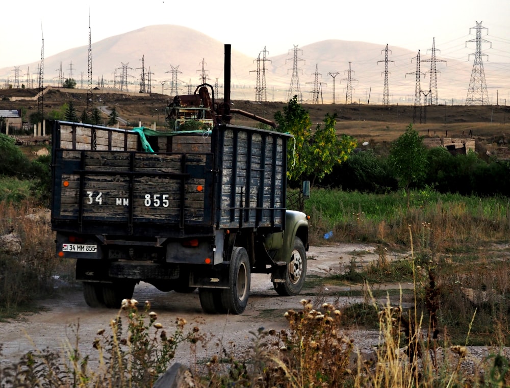 a large truck driving down a dirt road