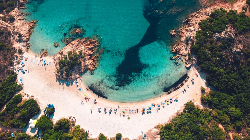 an aerial view of a sandy beach with blue water