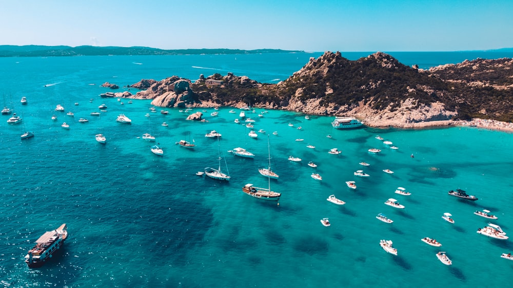 a group of boats floating on top of a body of water