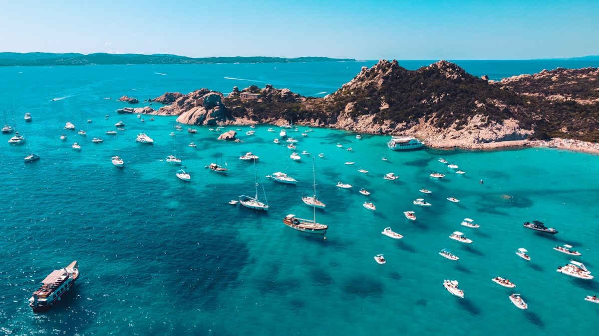 Sardinia June — empty turquoise bay with limestone cliffs