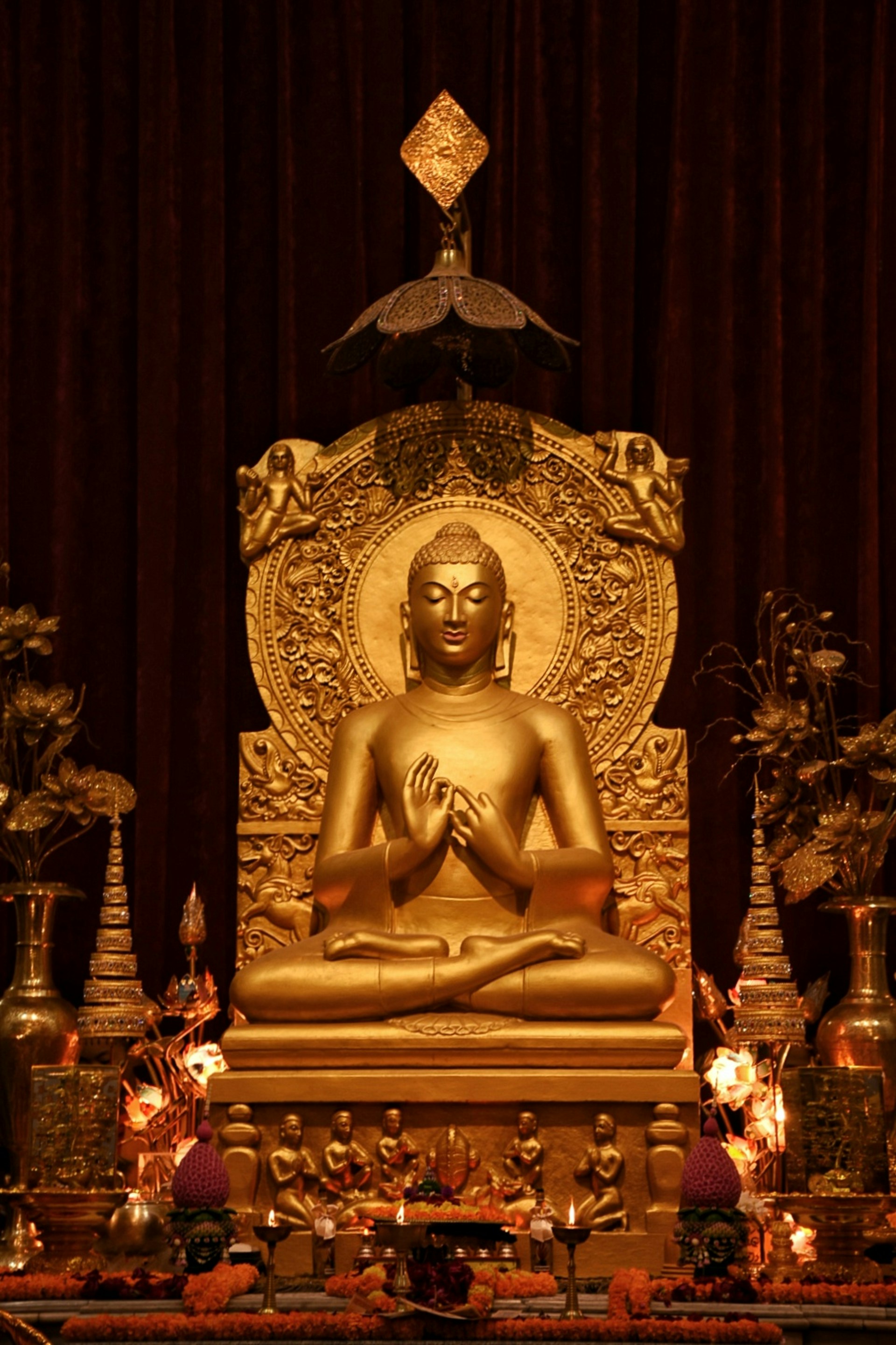a golden buddha statue sitting on top of a table