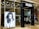 The entrance of a modern hair salon named Rush features sleek glass doors. Inside, the salon is stylishly presented with black chairs and lit mirrors. A large monochrome advertisement poster displays a model with voluminous hair, enhancing the salon's chic interior.