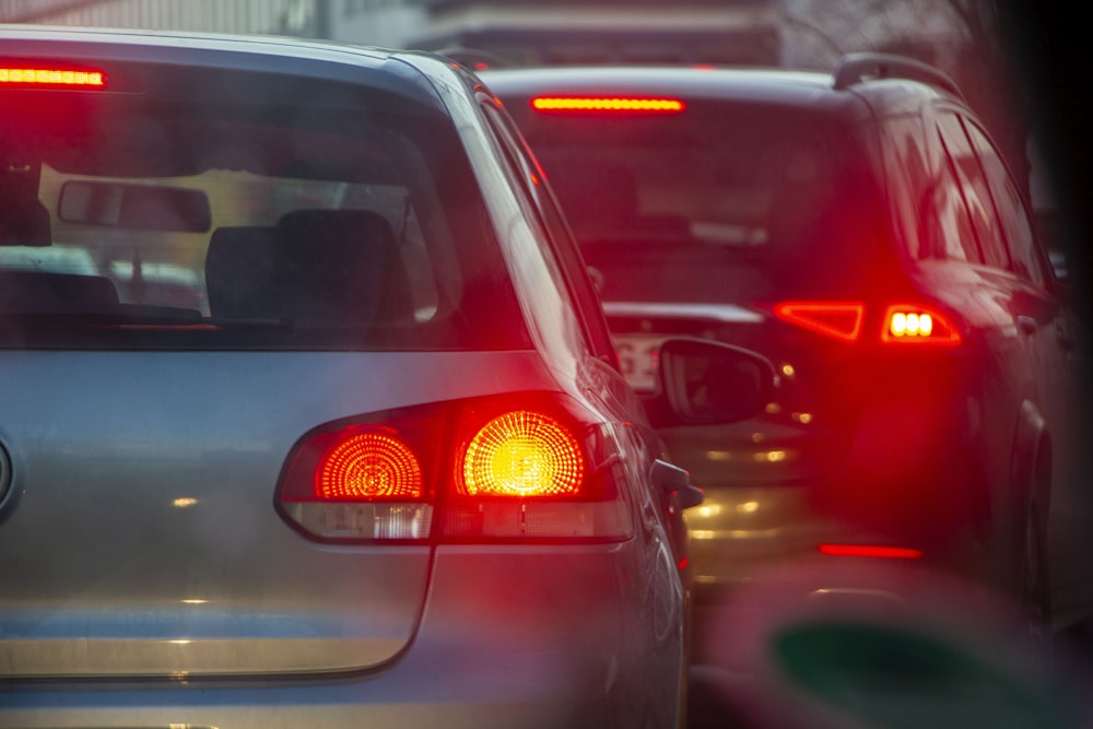 a group of cars driving down a street next to each other