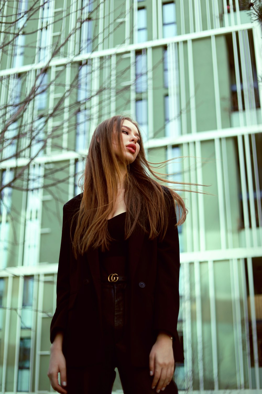 a woman standing in front of a tall building