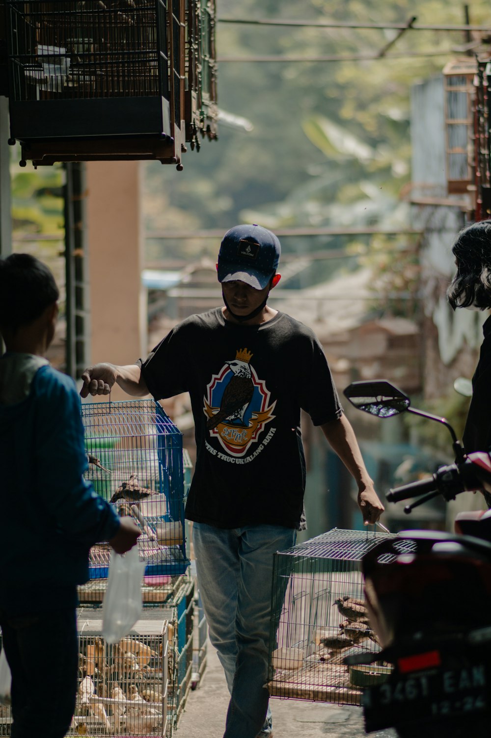 a man walking down a street next to a motorcycle